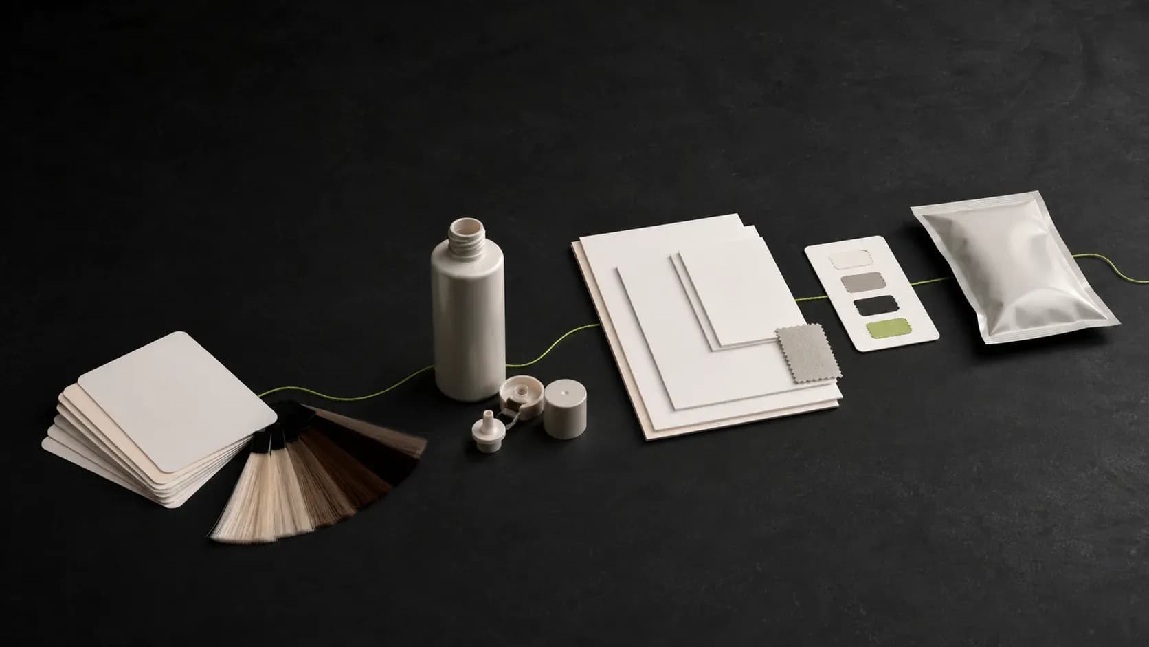 Blank brief cards, an unbranded sample container, packaging components, reference sheets, and a sealed sample connected across a dark project path.