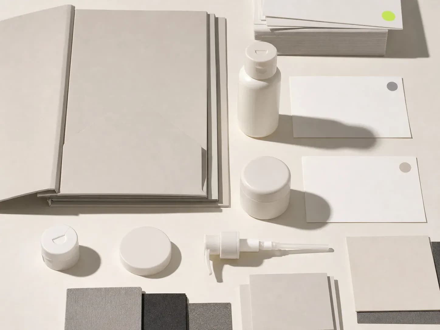 An unbranded Conditioner sample bottle and Mask sample jar beside blank version cards, packaging components, feedback sheets, and a specification folder.