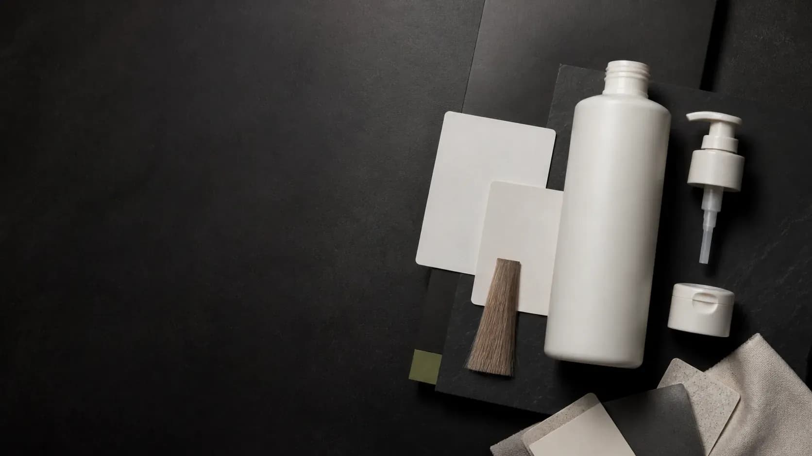 An unbranded Shampoo bottle, separate closure options, blank product-brief cards, and material swatches on a dark planning surface.